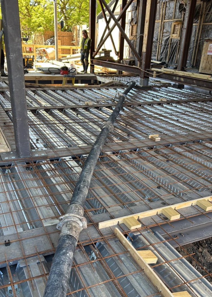 A King Concrete Pumping line pump feeding concrete on site near Banstead