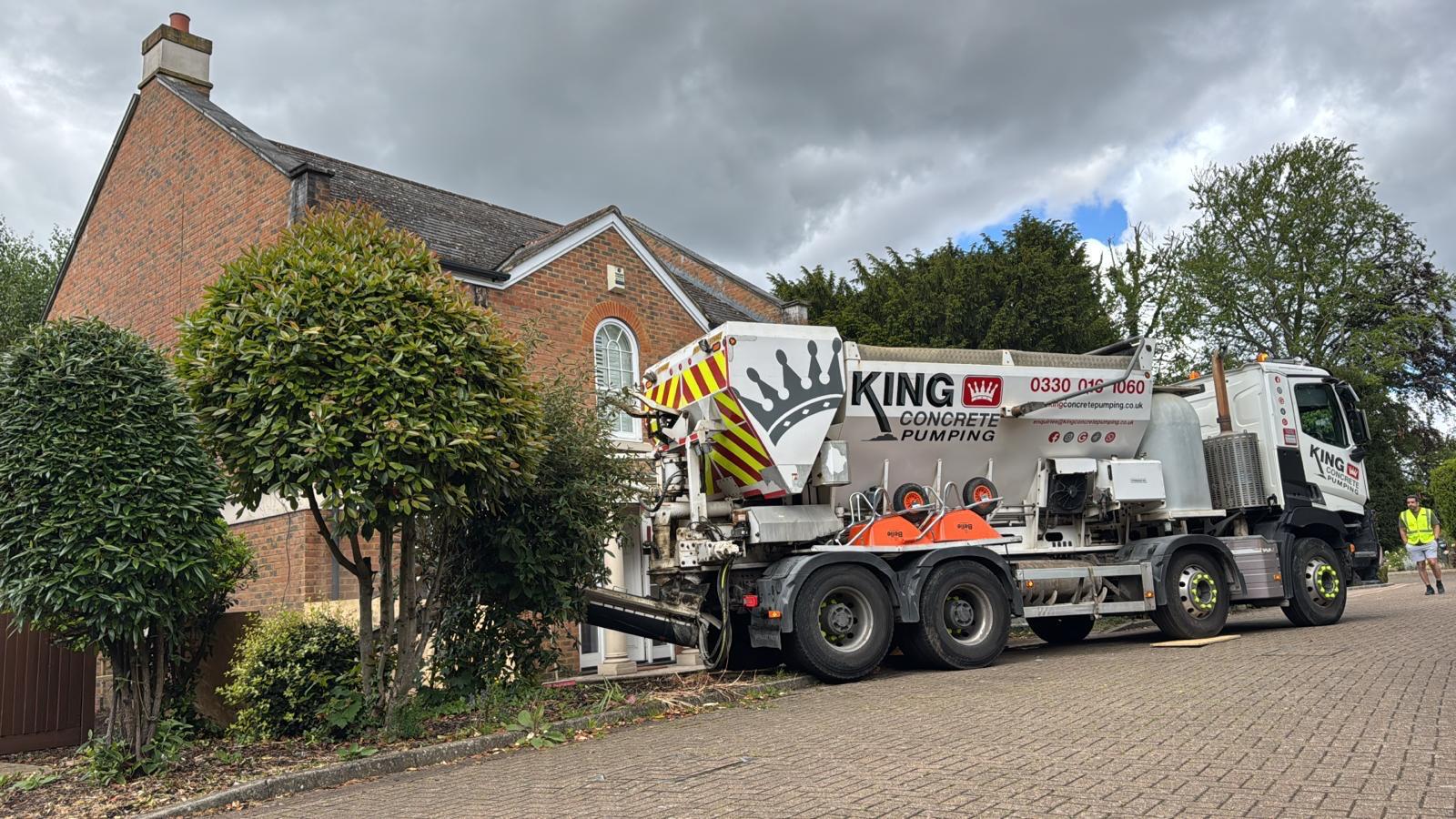 A boom pump placing concrete over a building